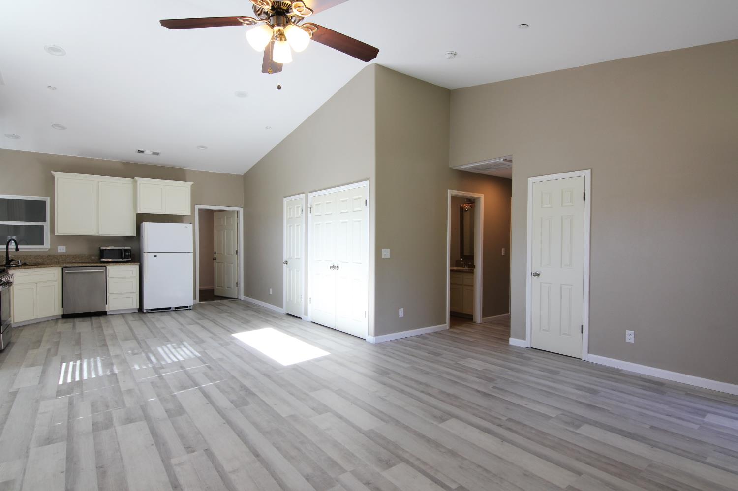 4968 Yaqui Gulch Road Mariposa, CA 95338 - Photo 7 of 28 a view of an empty room with a window and wooden floor