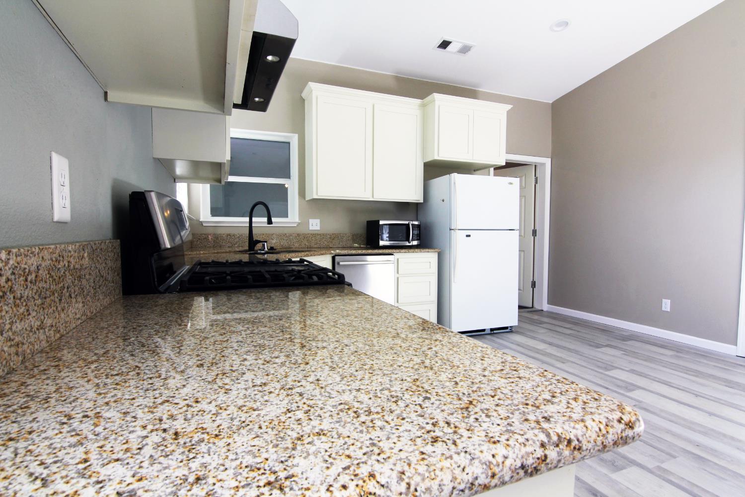 4968 Yaqui Gulch Road Mariposa, CA 95338 - Photo 9 of 28 a kitchen with a refrigerator sink and cabinets