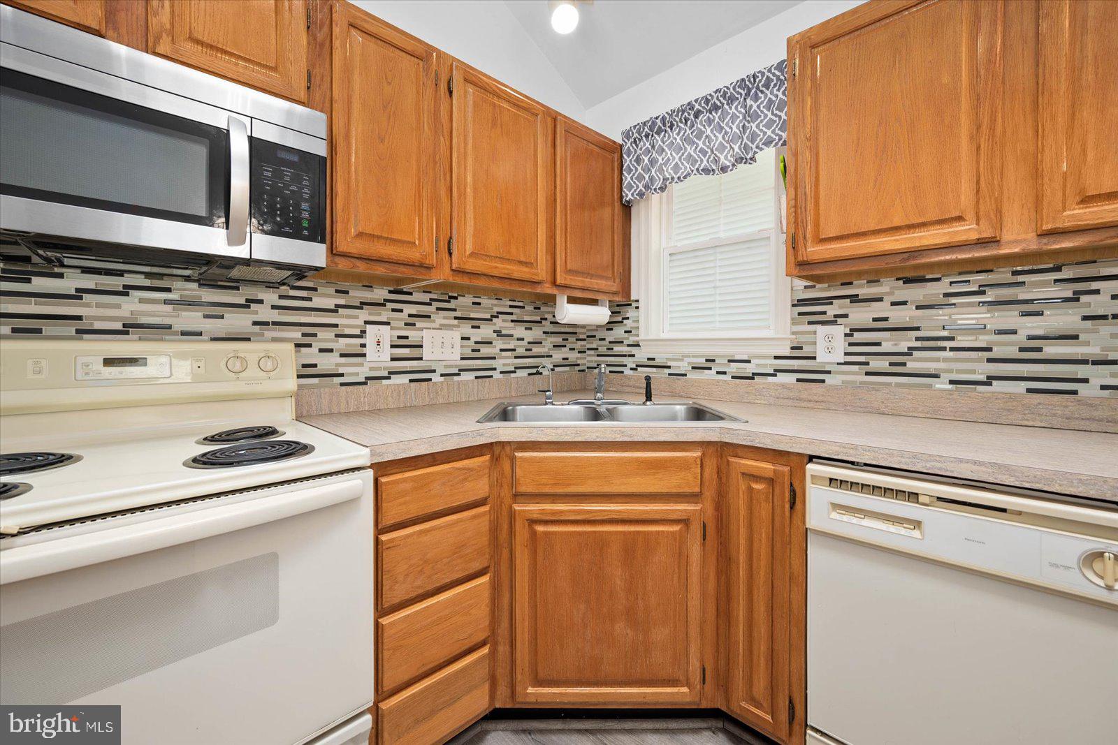 156 Sandyhook Road Berlin, MD 21811 - Photo 13 of 95 a kitchen with stainless steel appliances granite countertop a sink stove and microwave
