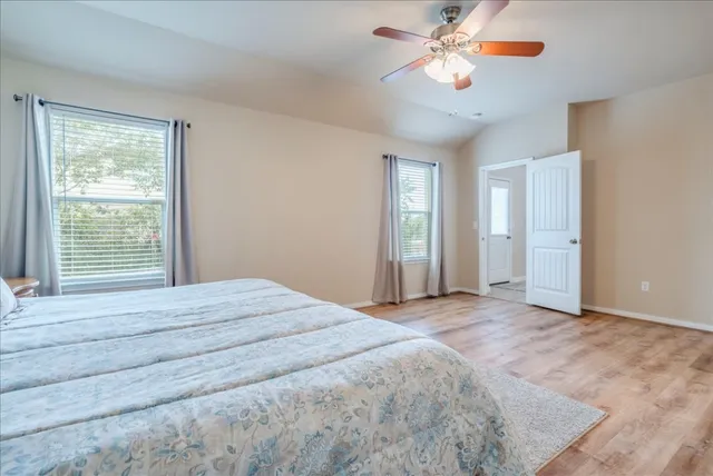 a view of a room with a ceiling fan and a window