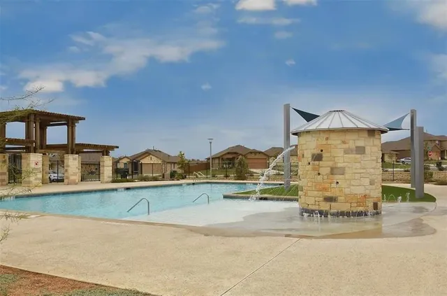 a swimming pool with outdoor seating and yard