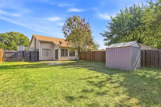 a view of a house with backyard and sitting area