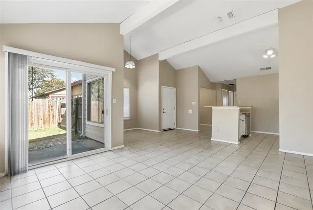 a view of a livingroom with an empty space and a window