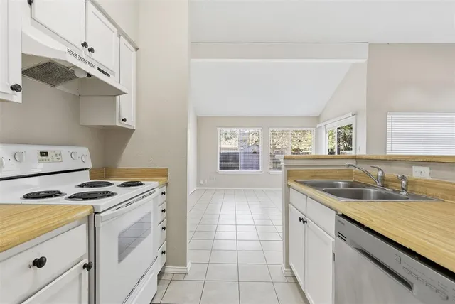 a kitchen that has a sink and a stove