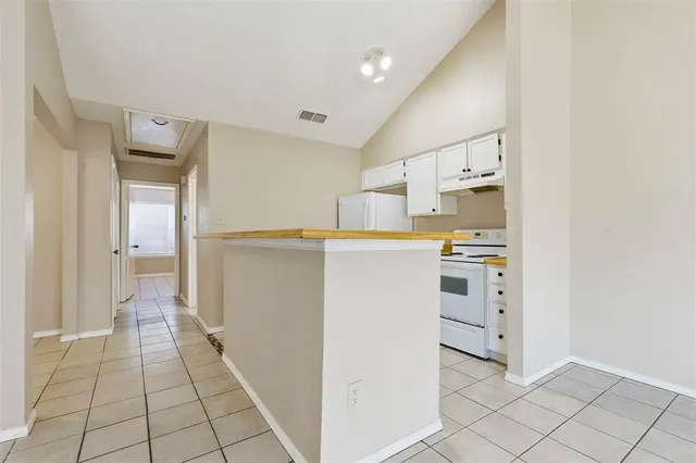 a utility room with cabinets washer and dryer
