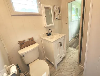a white toilet sitting next to a bathroom sink