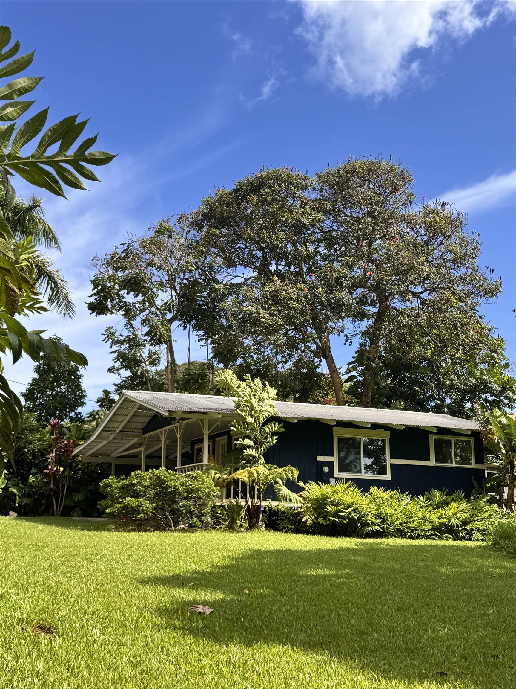 91 Wailua Road Haiku, HI 96708 - Photo 2 of 14 a front view of a house with a garden