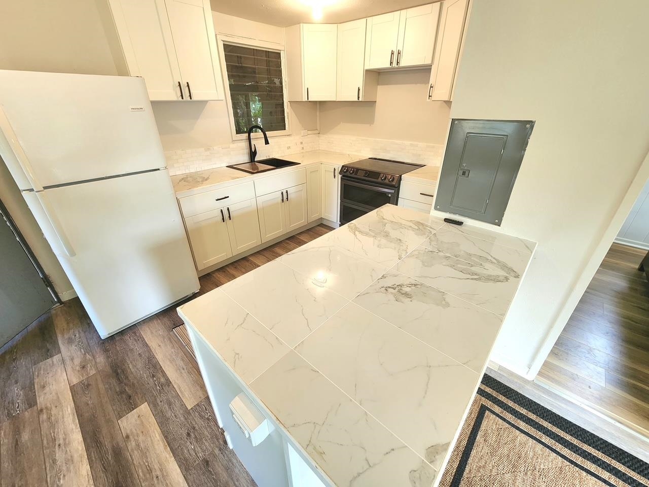 91 Wailua Road Haiku, HI 96708 - Photo 9 of 14 a kitchen with a sink a stove and a refrigerator