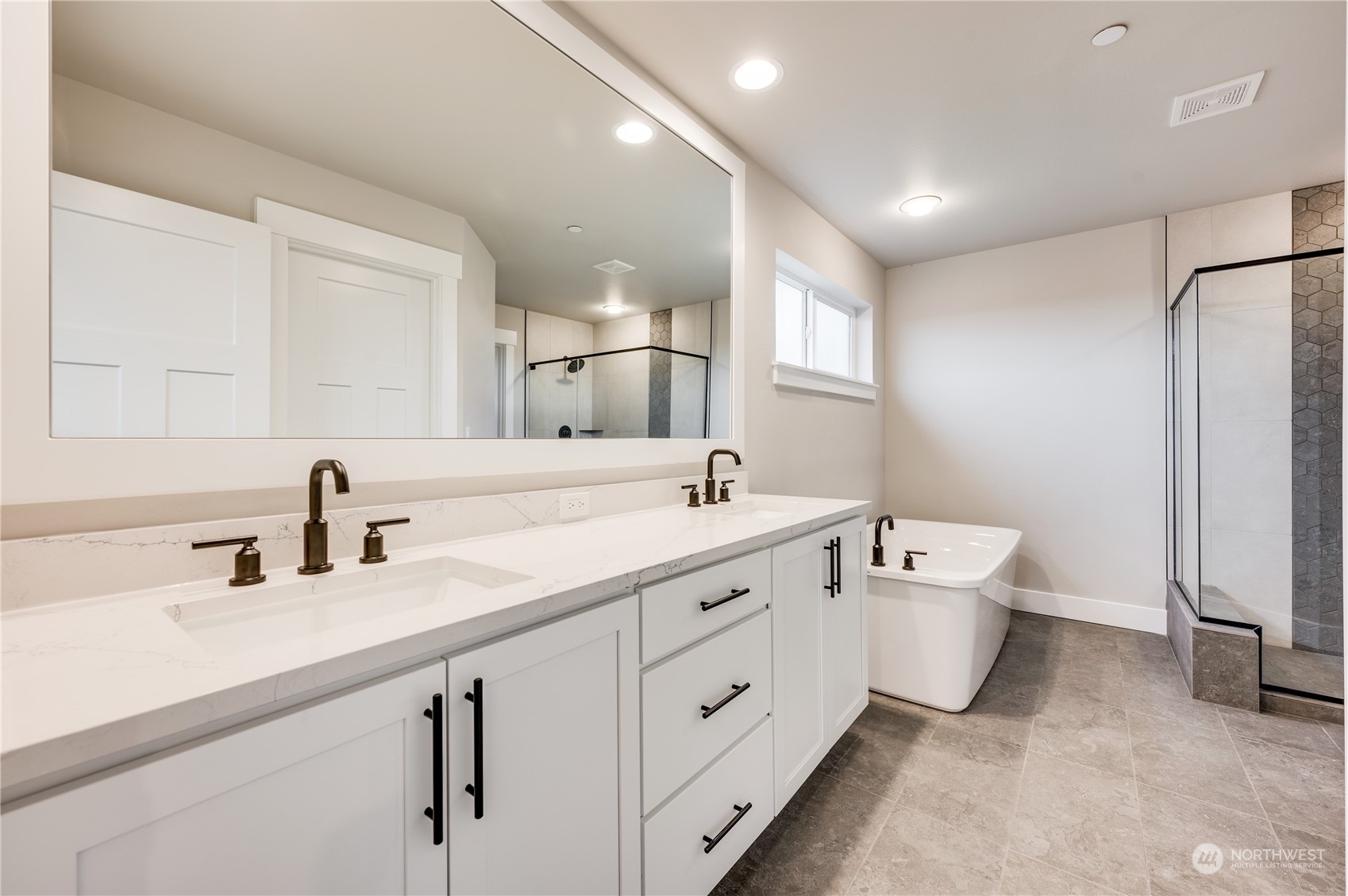 24326 43rd Drive Southeast Bothell, WA 98021 - Photo 28 of 35 a spacious bathroom with double sink a mirror and a bathtub