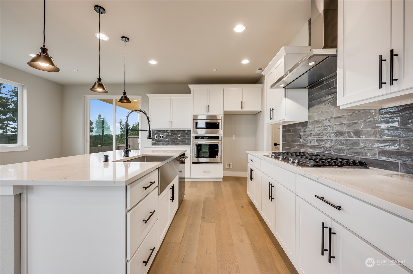 24326 43rd Drive Southeast Bothell, WA 98021 - Photo 8 of 35 a large kitchen with stainless steel appliances kitchen island a large counter tops a stove a sink and a refrigerator