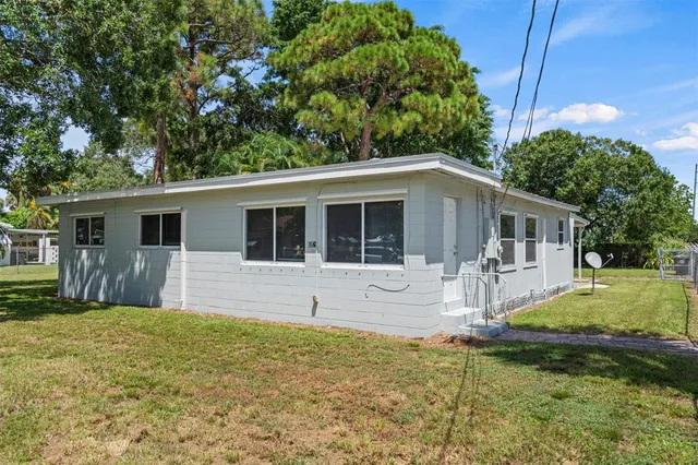 a front view of house with yard outdoor seating and barbeque oven