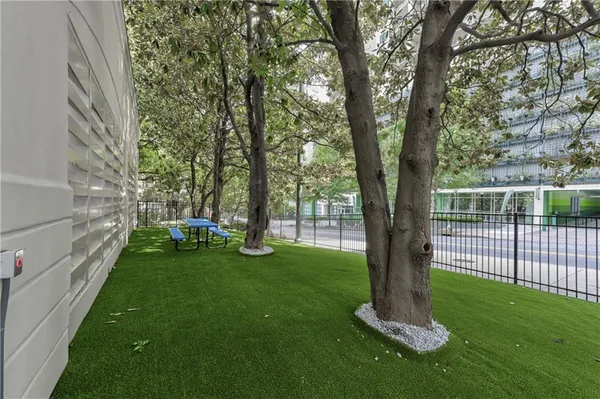 a view of a backyard with large trees