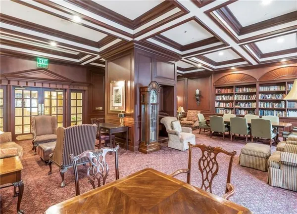 a living room with lots of furniture and a chandelier