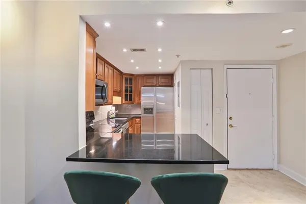 a view of kitchen with kitchen island dining table and chairs