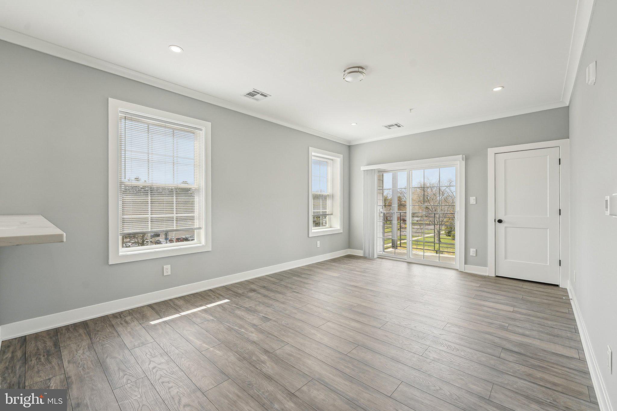 2421 Bristol Road, Unit 2B310 Warrington, PA 18976 - Photo 23 of 50 a view of an empty room with wooden floor and a window