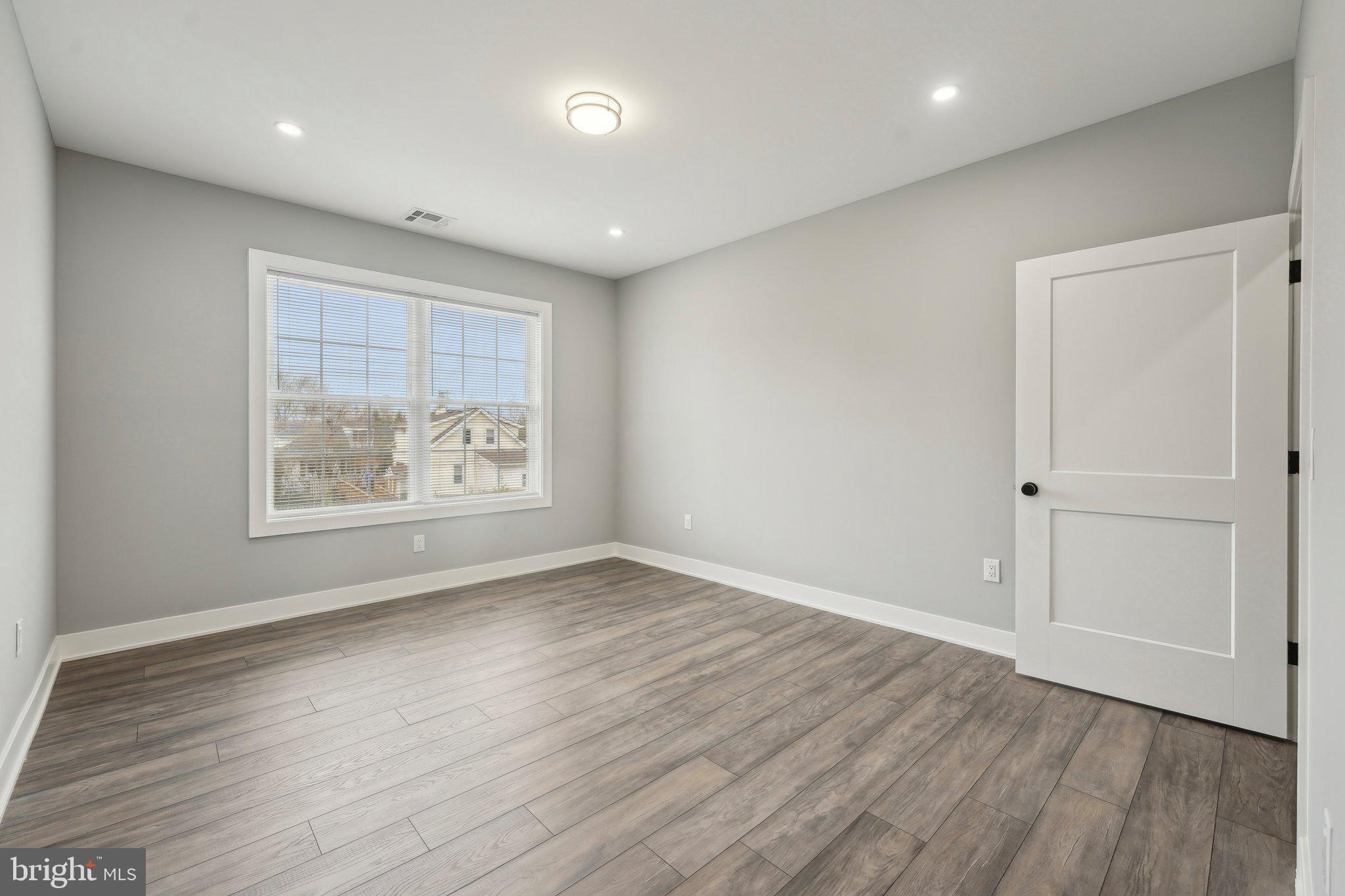 2421 Bristol Road, Unit 2B310 Warrington, PA 18976 - Photo 29 of 50 an empty room with wooden floor and window