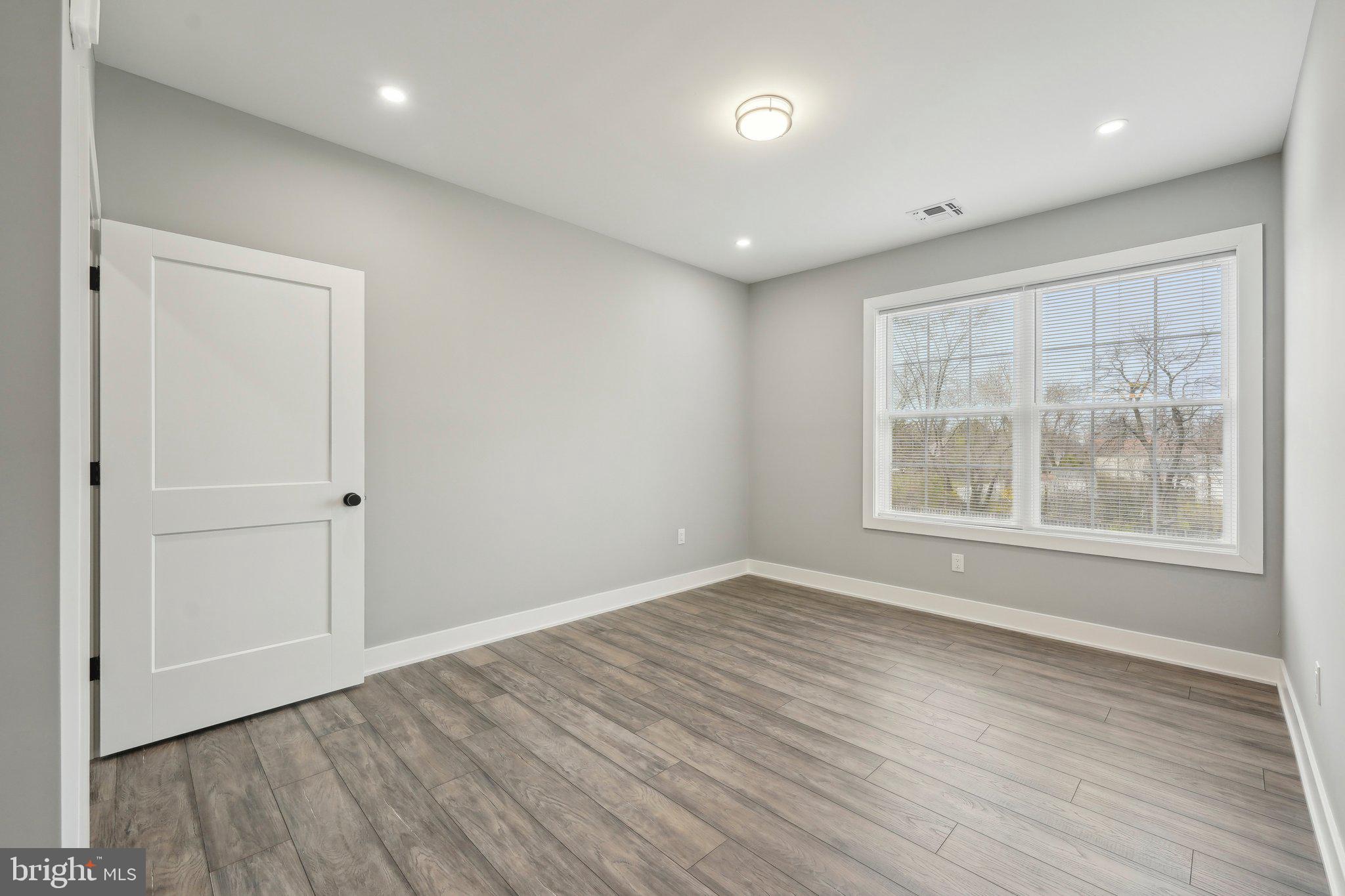 2421 Bristol Road, Unit 2B310 Warrington, PA 18976 - Photo 31 of 50 an empty room with wooden floor and windows