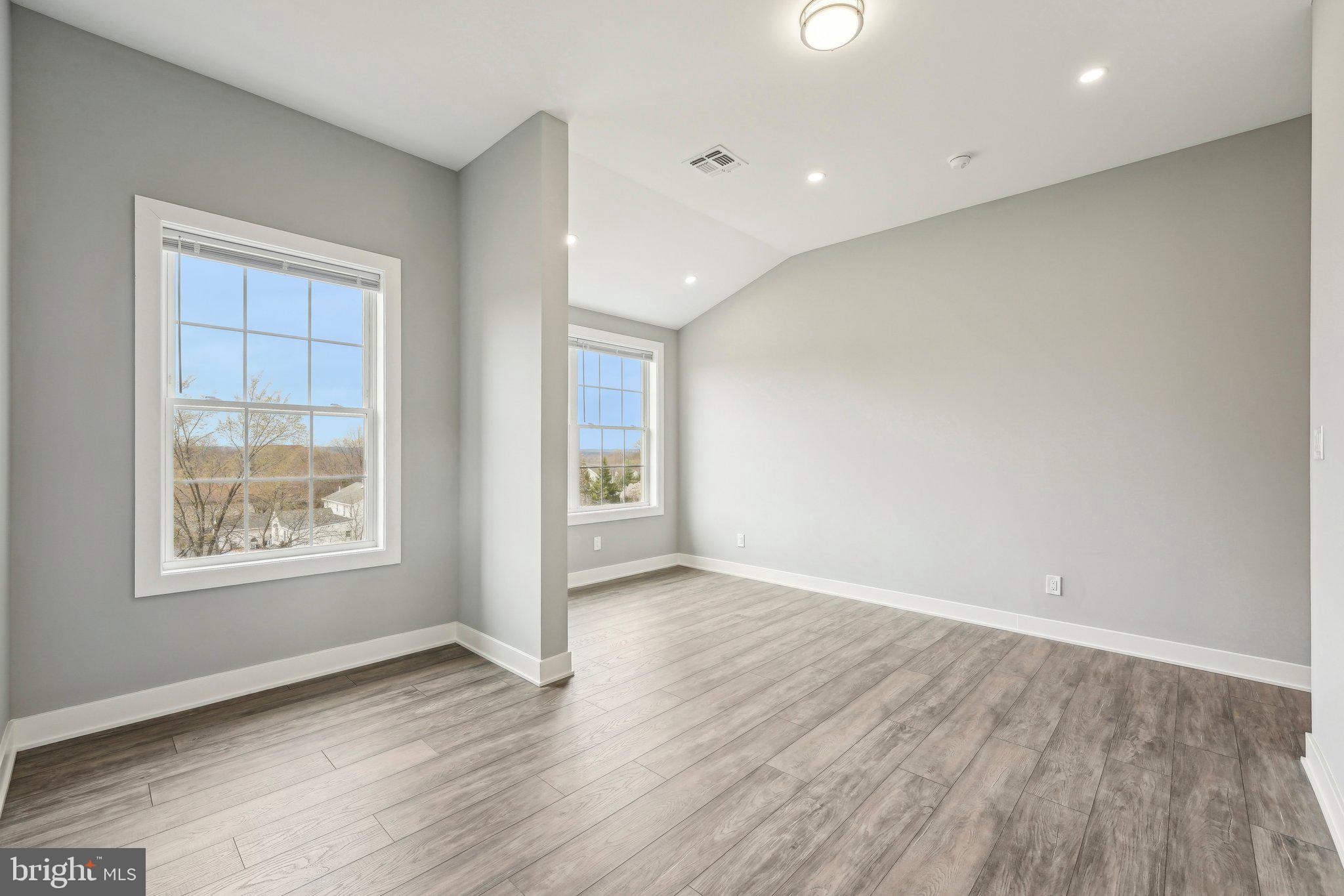 2421 Bristol Road, Unit 2B310 Warrington, PA 18976 - Photo 5 of 50 an empty room with wooden floor and windows