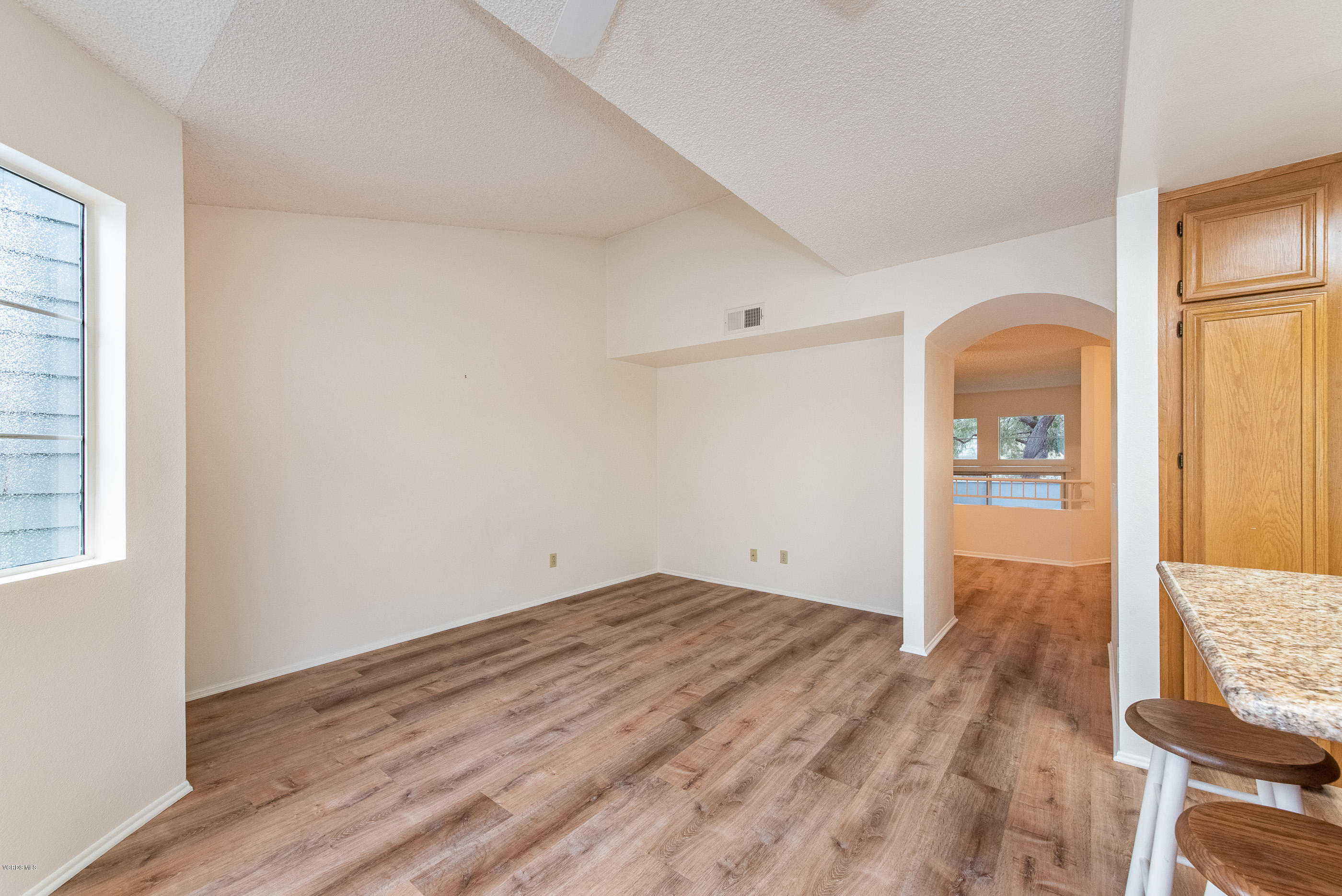 4975 Telephone Road Ventura, CA 93003 - Photo 15 of 31 an empty room with wooden floor and windows
