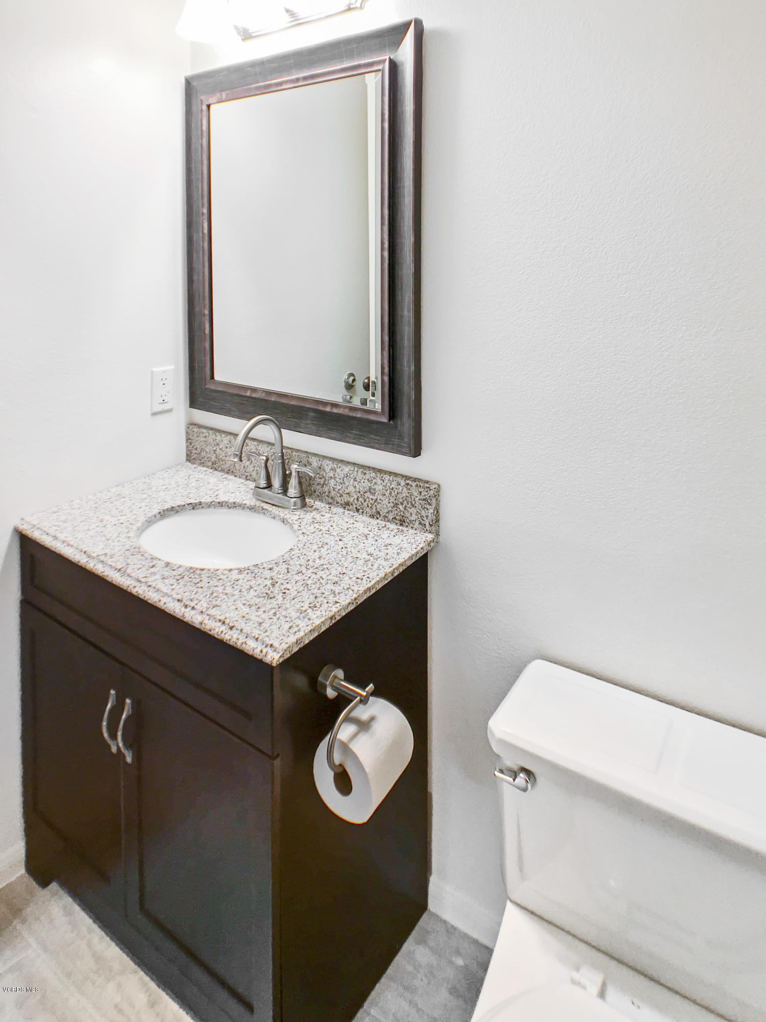 4975 Telephone Road Ventura, CA 93003 - Photo 18 of 31 a bathroom with a granite countertop toilet sink and mirror