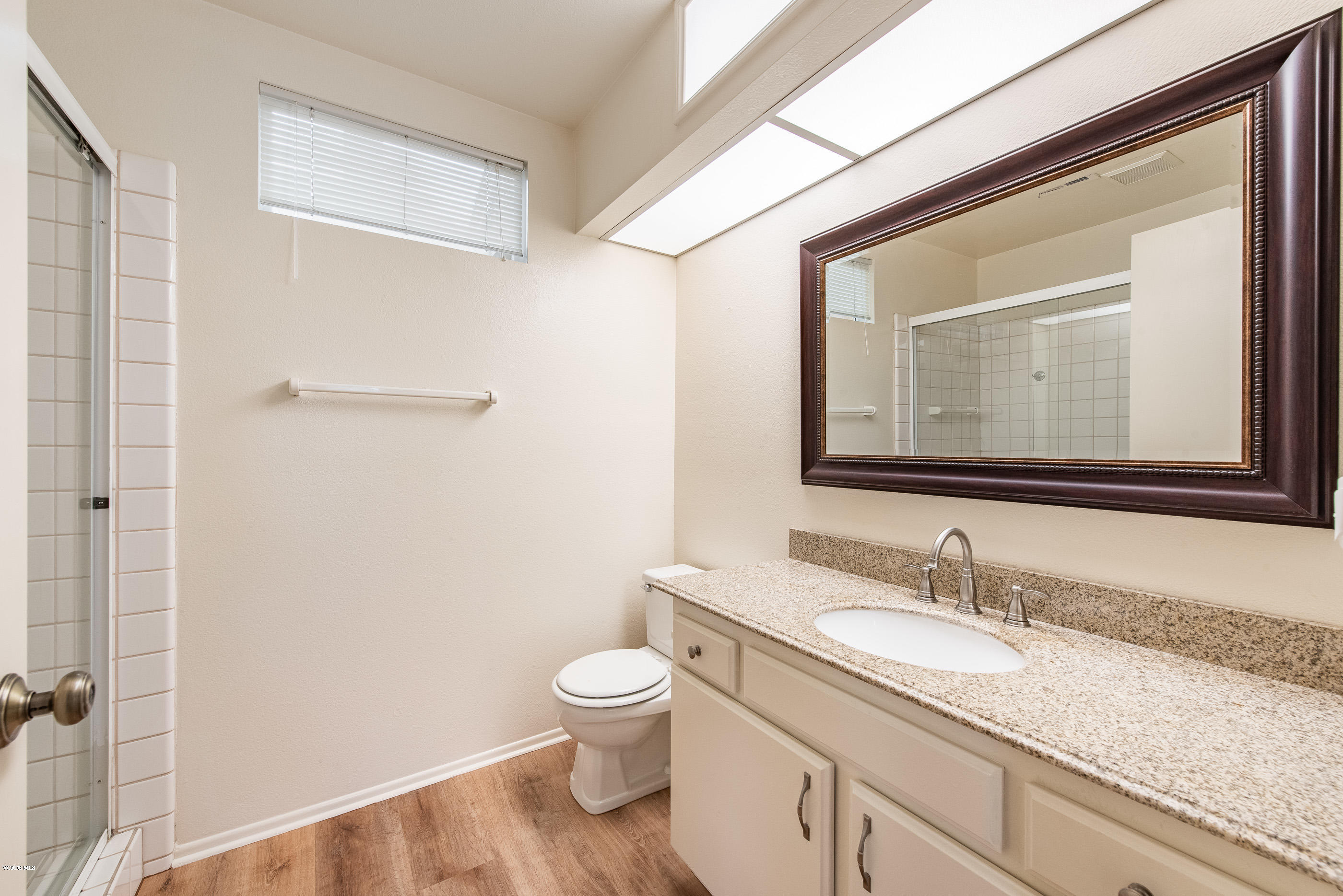 4975 Telephone Road Ventura, CA 93003 - Photo 21 of 31 a bathroom with a granite countertop sink toilet and shower