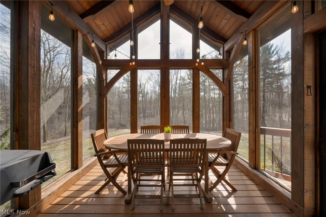 11295 Sutton Place Chardon, OH 44024 - Photo 45 of 50 Sunroom featuring a wood ceiling with exposed beams, floor to ceiling windows, and hardwood / wood-style flooring
