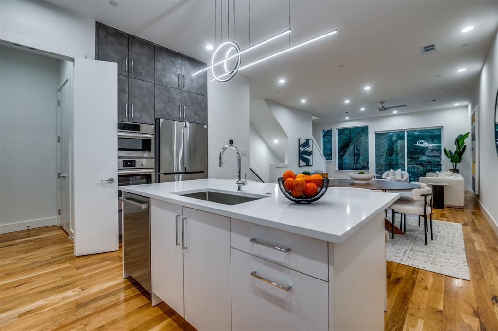 4133 North Reserve Lane Addison, TX 75001 - Photo 11 of 20 a kitchen with a sink and cabinets