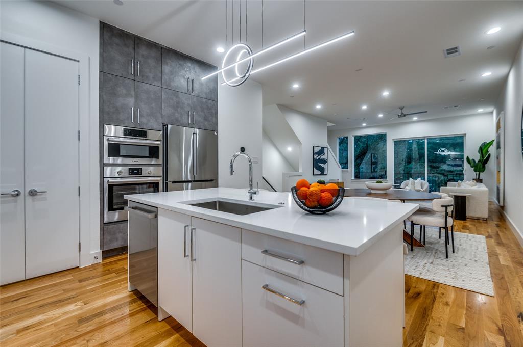 4133 North Reserve Lane Addison, TX 75001 - Photo 12 of 20 a kitchen with a sink and cabinets