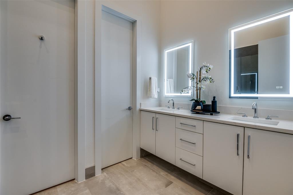 4133 North Reserve Lane Addison, TX 75001 - Photo 15 of 20 a bathroom with a double vanity sink and a mirror