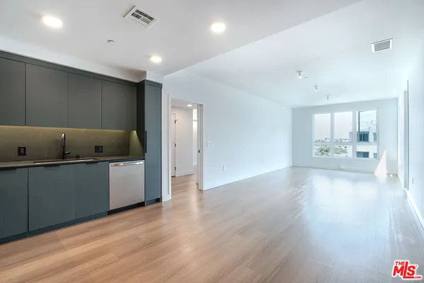 a view of kitchen and center with wooden floor