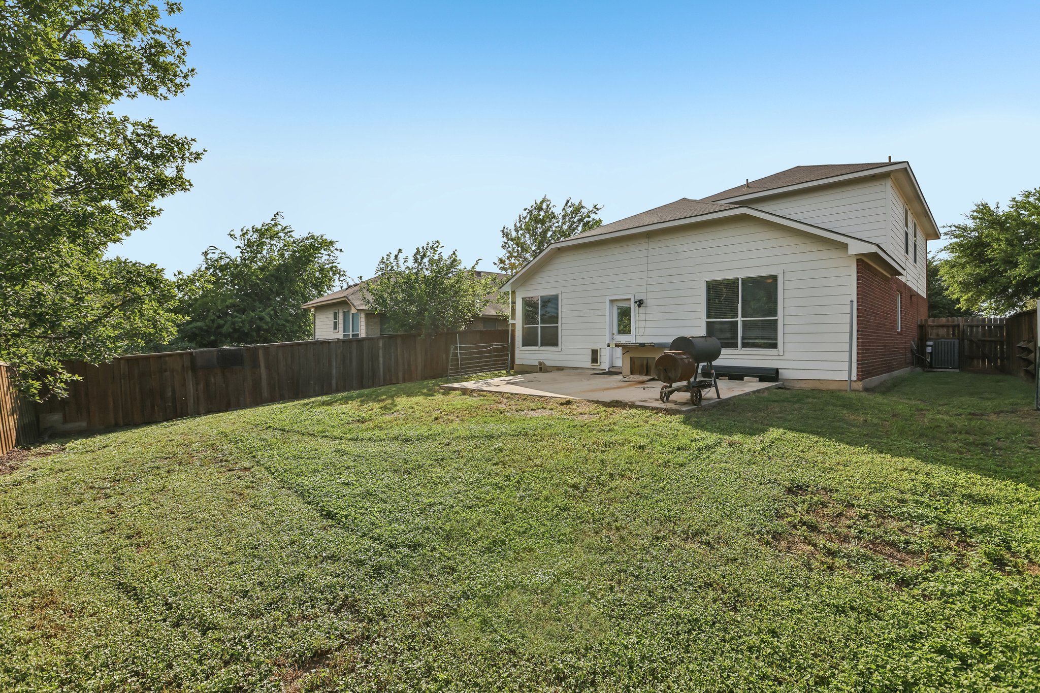 1721 Long Rifle Drive Austin, TX 78754 - Photo 32 of 38 A spacious yard perfect for outdoor enjoyment extends from a cozy patio.