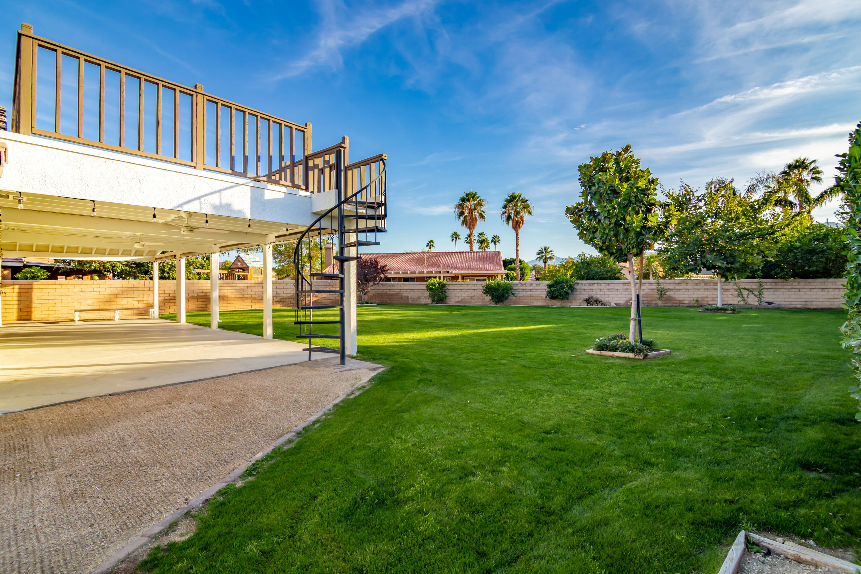 80265 Moonshadow Drive Indio, CA 92201 - Photo 14 of 32 a view of a fountain in front of a house with a yard