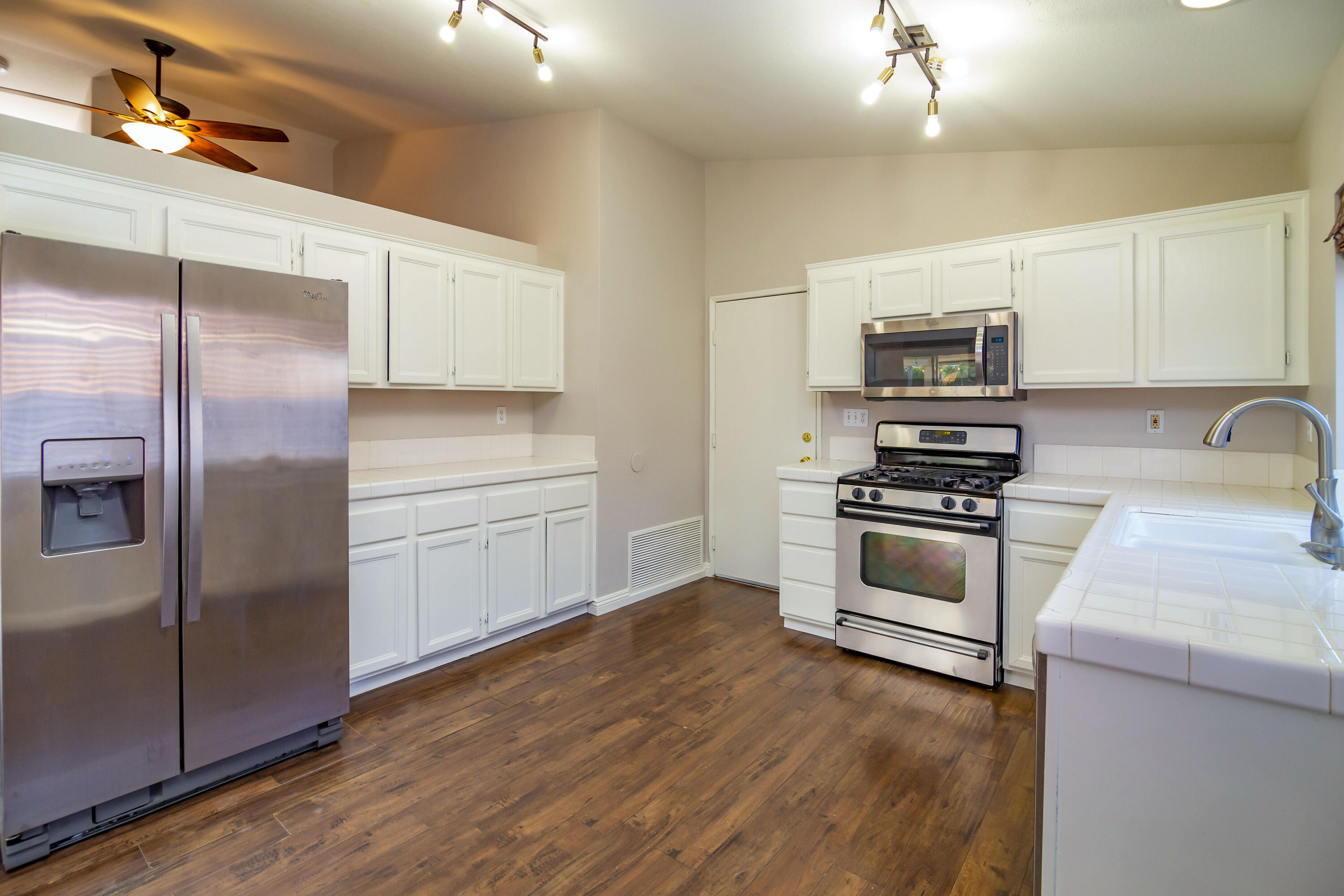 80265 Moonshadow Drive Indio, CA 92201 - Photo 21 of 32 a kitchen with kitchen island granite countertop a refrigerator and a stove top oven