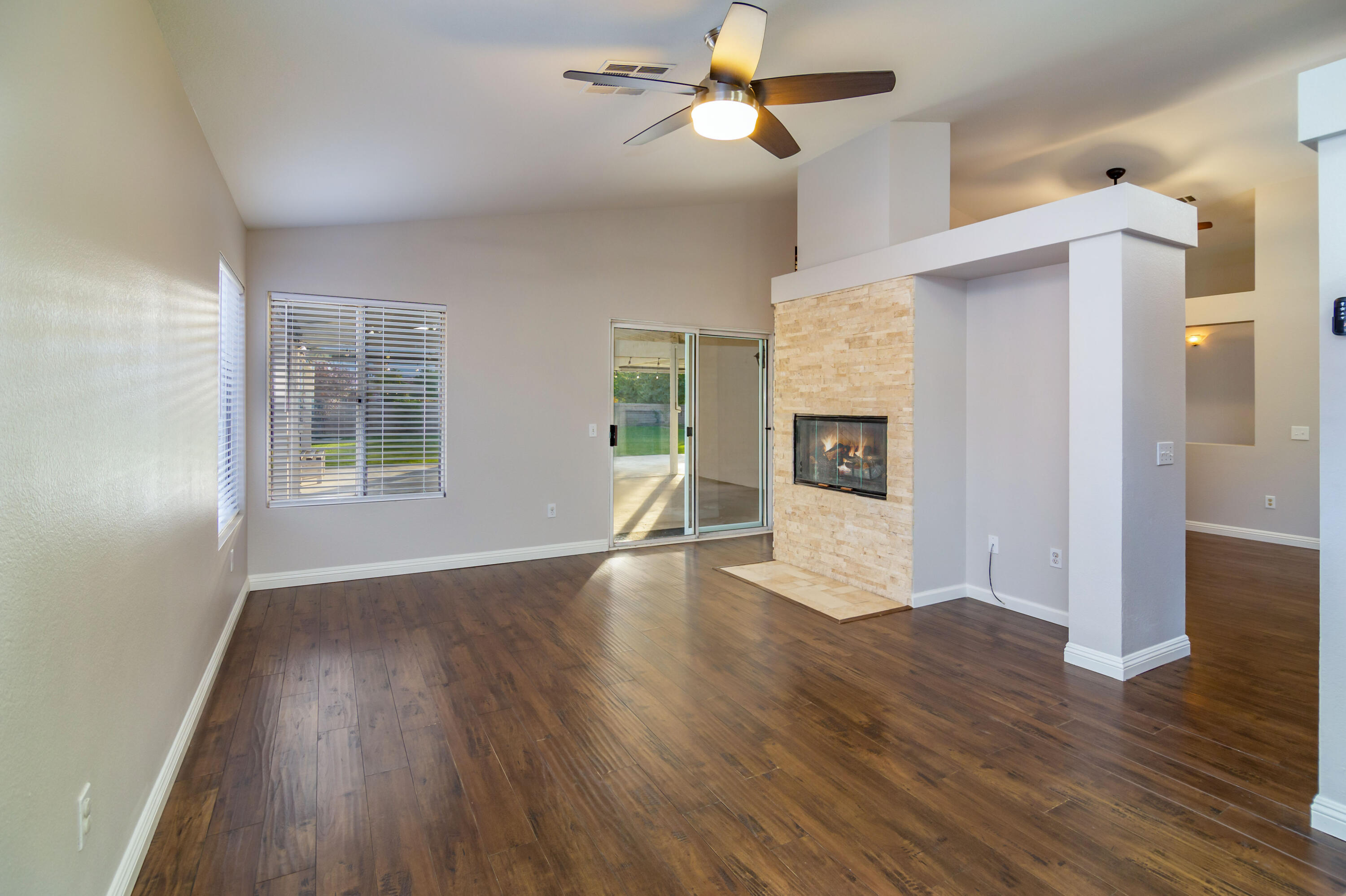 80265 Moonshadow Drive Indio, CA 92201 - Photo 22 of 32 a view of empty room with wooden floor and fireplace