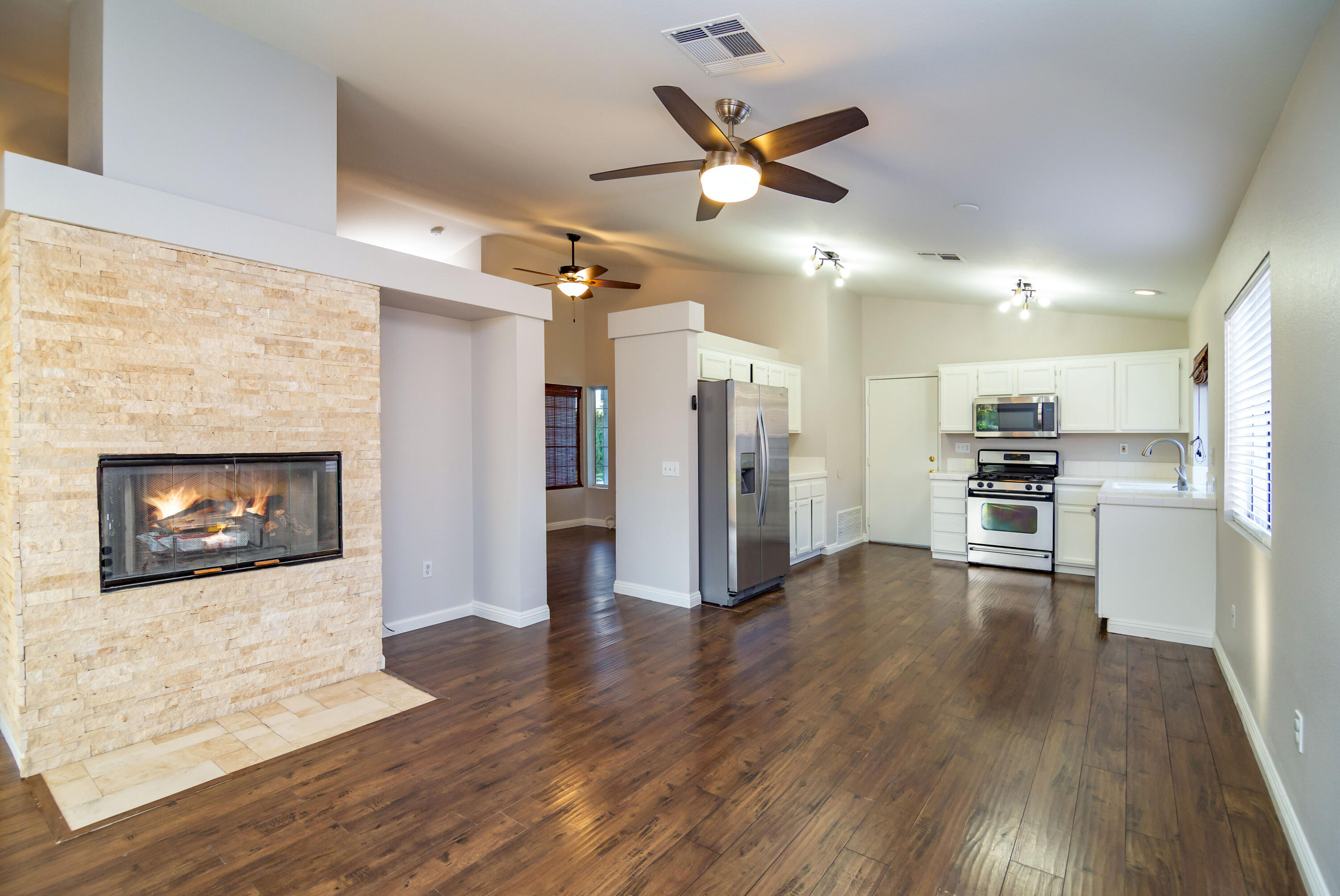 80265 Moonshadow Drive Indio, CA 92201 - Photo 23 of 32 a view of a kitchen with a sink a refrigerator and wooden floor