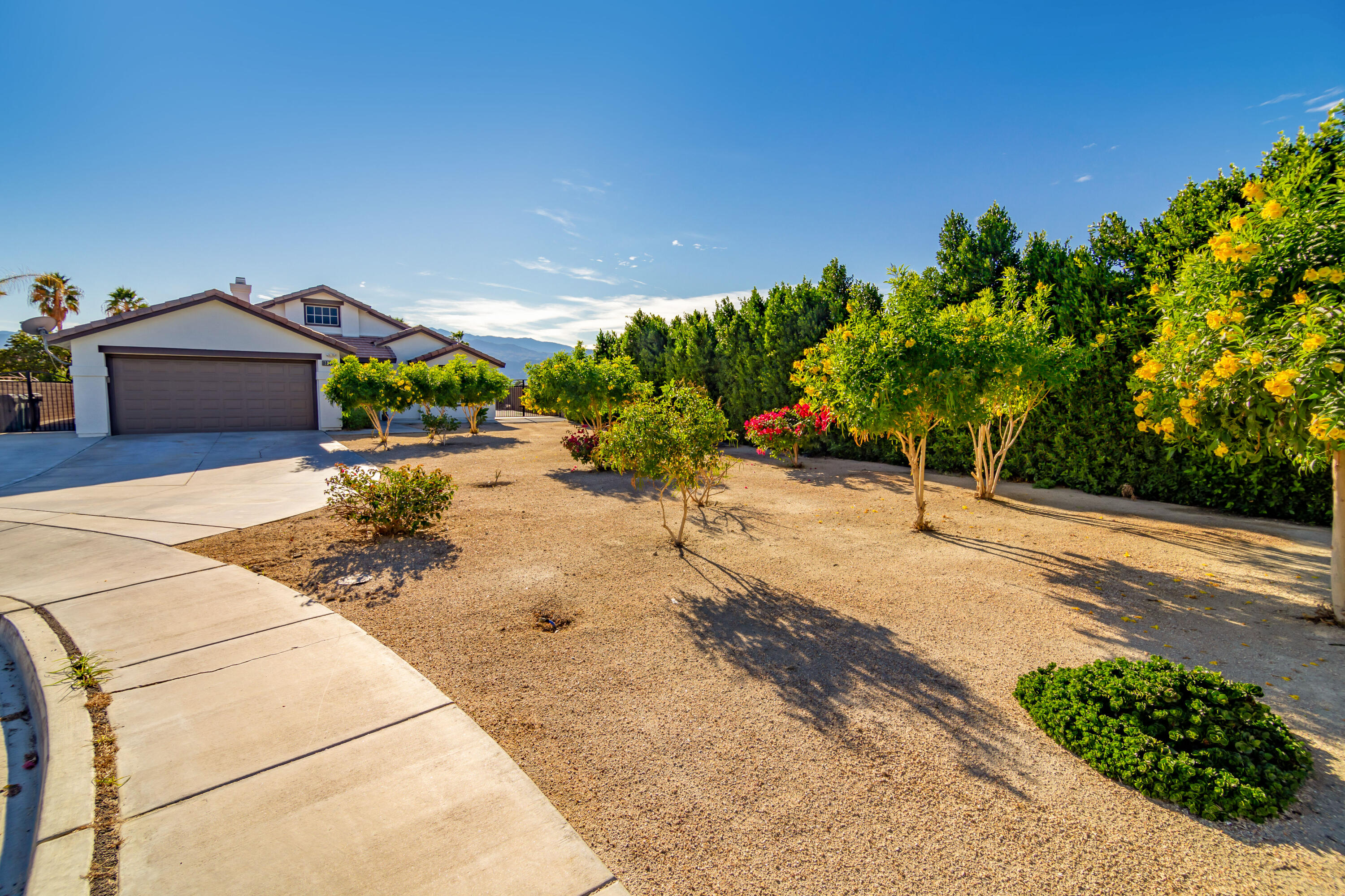 80265 Moonshadow Drive Indio, CA 92201 - Photo 3 of 32 a view of a street with a view of a house