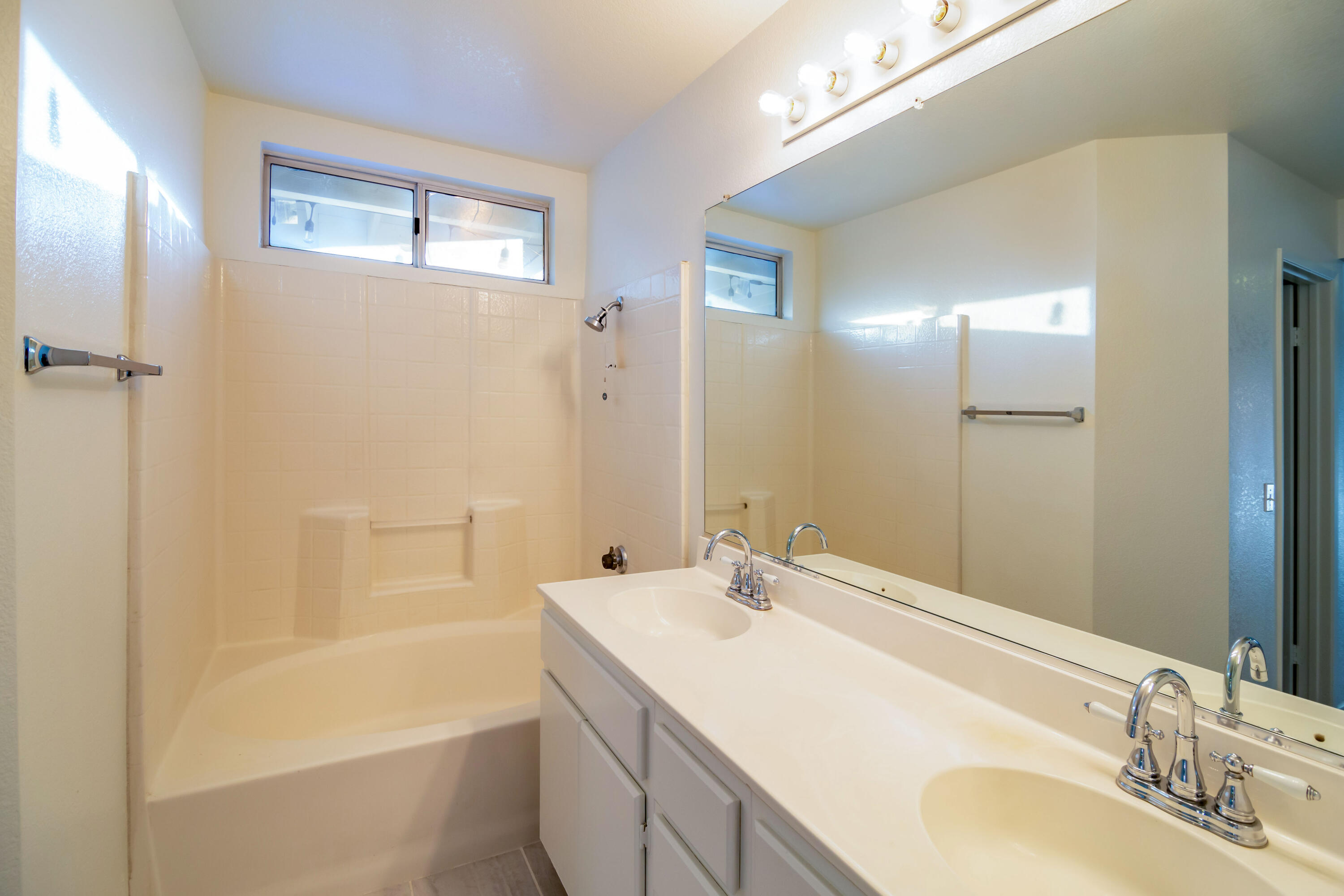80265 Moonshadow Drive Indio, CA 92201 - Photo 31 of 32 a bathroom with a bathtub shower sink vanity and mirror