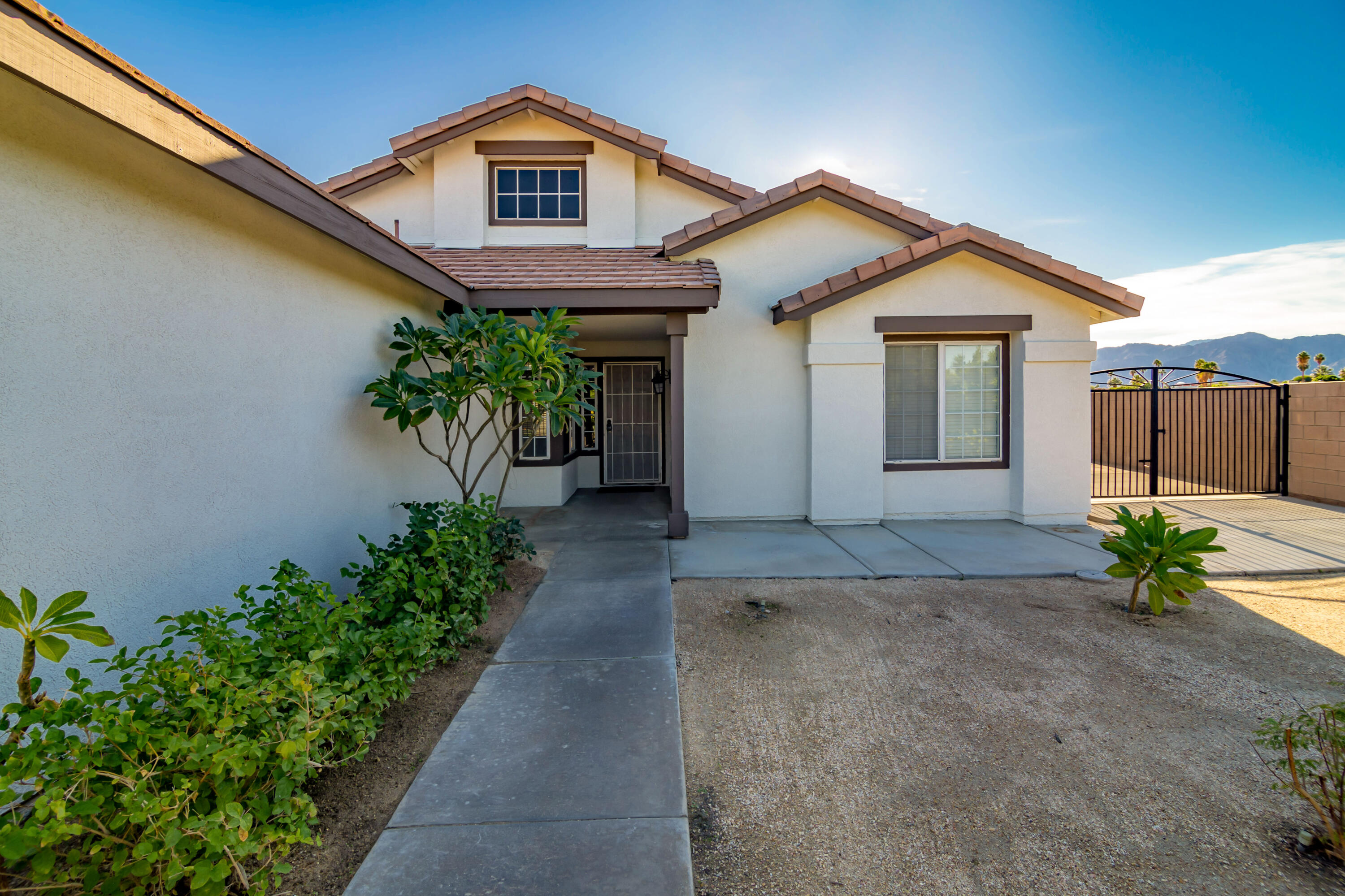80265 Moonshadow Drive Indio, CA 92201 - Photo 5 of 32 a view of a house with potted plants