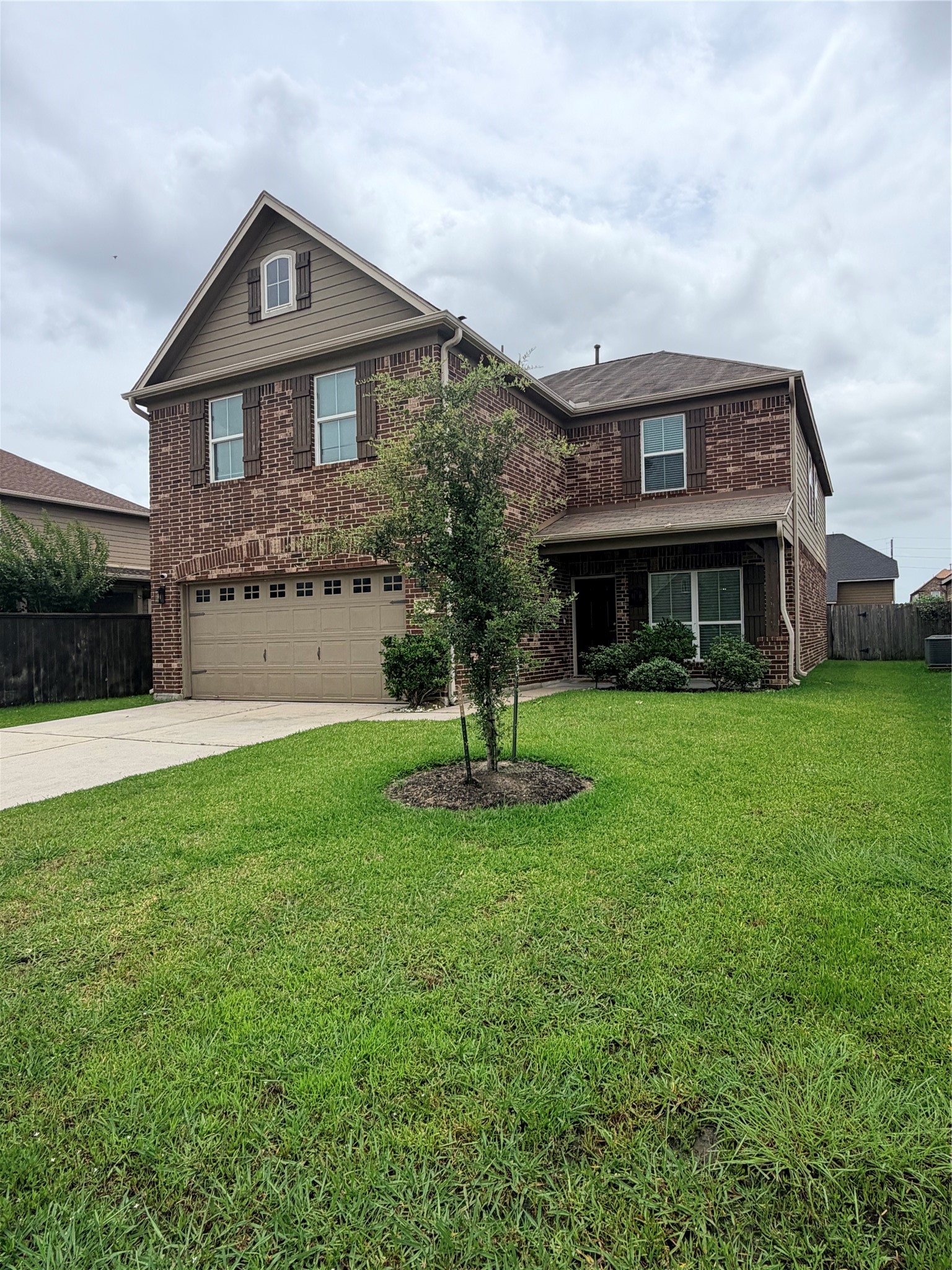 3226 Dappled Vale Trail Spring, TX 77373 - Photo 26 of 26 This is a two-story brick house with a two-car garage. It features a well-maintained lawn and a small tree in the front yard, offering great curb appeal.