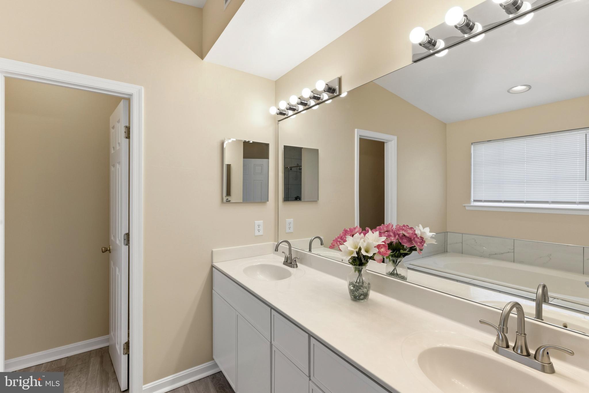 4704 Denview Way Baltimore, MD 21206 - Photo 26 of 42 a bathroom with a double vanity sink and mirror