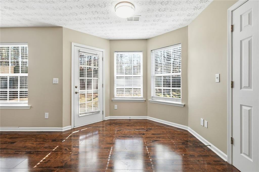 3570 Bogan Mill Road Northeast Buford, GA 30519 - Photo 12 of 31 a view of empty room with wooden floor and fan