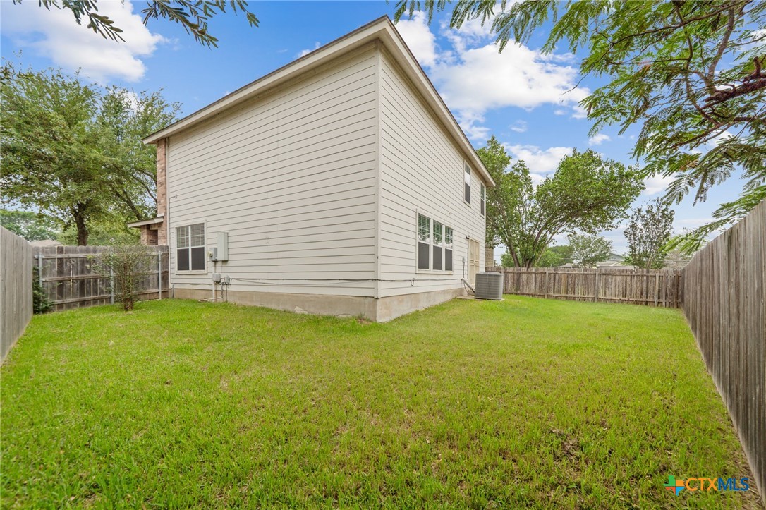 109 Comal Cove Elgin, TX 78621 - Photo 33 of 34 a view of a backyard with a garden