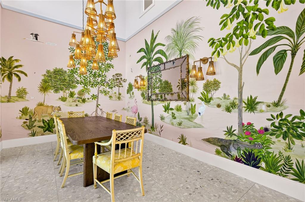 111 Caribbean Road Naples, FL 34108 - Photo 18 of 50 a patio with a table and chairs and potted plants