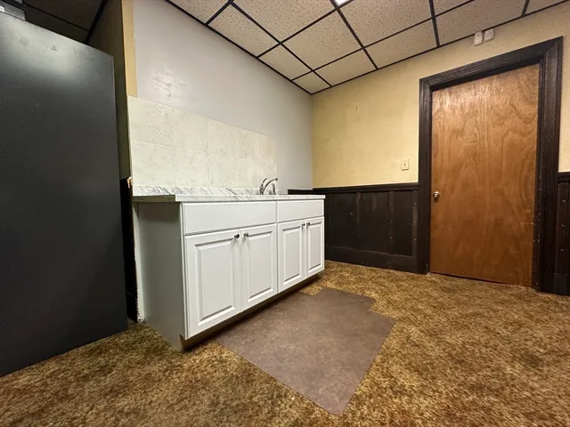 a kitchen with stainless steel appliances granite countertop a refrigerator