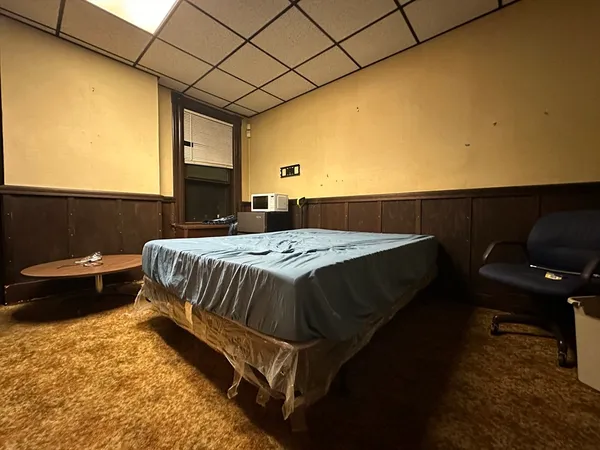a bed sitting in a bedroom next to a window