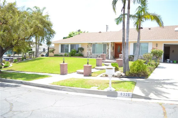 a view of a white house with a swimming pool and a yard