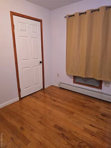a view of a room with wooden floor and closet
