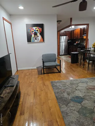 a bedroom with furniture and a flat screen tv