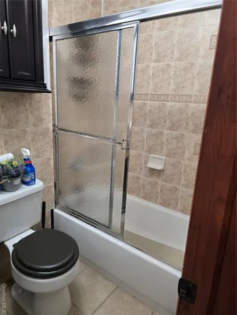 a bathroom with a shower and a toilet