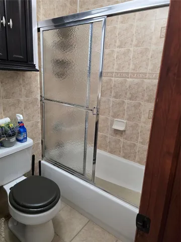 a bathroom with a shower and a toilet
